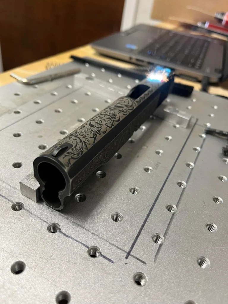 1911 floral slide laser engraving at Snyder Precision.